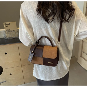 Detail of vintage color-block crossbody bag with brown leather and khaki suede texture