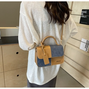 Retro two-tone handbag in brown leather and blue denim patchwork for women
