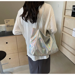 Detail of holographic silver tote bag with shiny iridescent finish and minimalist handle
