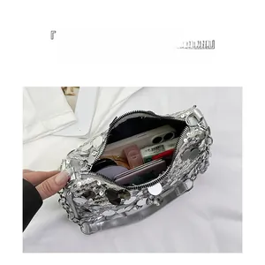 Detail view of silver sequined shoulder bag interior with ample space for essentials
