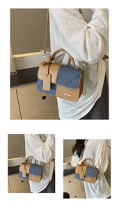 Detail of retro color-block handbag with denim fabric and metallic buckle closure