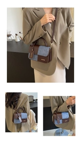 Close-up of contrast stitching, brown leather, and blue denim fabric on crossbody bag