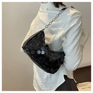 Detailed view of black sequin hobo shoulder bag with silver chain on model