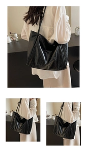 Detailed view of black high-capacity tote bag with glossy vintage oil wax leather texture