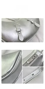 Macro detail of silver crescent shoulder bag featuring metallic crinkle texture and hardware