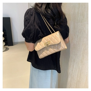 Elegant beige quilted chain bag with gold metal hardware for shoulder or crossbody wear