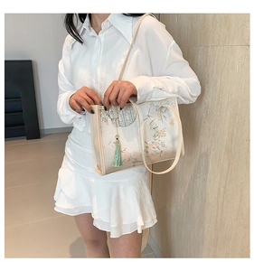Detailed view of the Chinese style silk tote bag with landscape pattern and green tassel