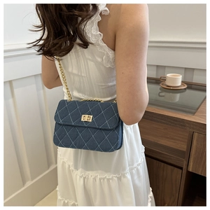 Quilted denim chain crossbody bag in dark blue with gold-tone hardware for women