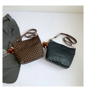 Detailed view of vintage monogram bucket bags with wide straps and plush bear charms