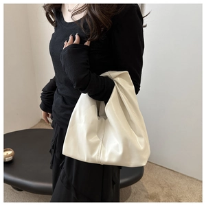 Close-up of creamy white soft PU leather hobo bag with pleated stitching details