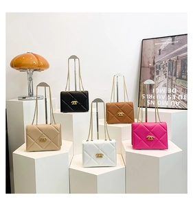 Detail of elegant quilted crossbody bags with gold chain straps in multiple colors