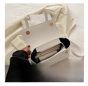 Interior view showing the large capacity of this white minimalist leather handbag