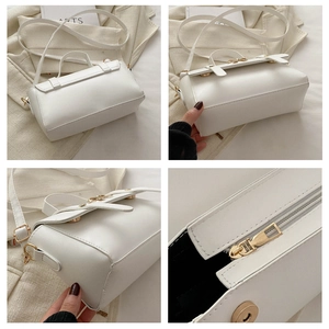 Detail view of white PU leather crossbody bag showing gold hardware and inner lining