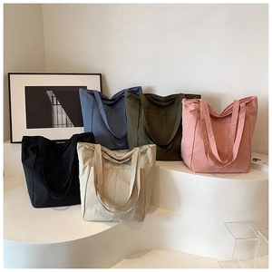 Minimalist large nylon bucket bag in multiple colors displayed on a modern white stand