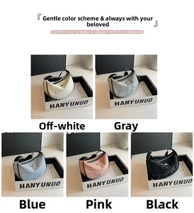 Detail of hobo shoulder bag showing five color options and textured fabric finish