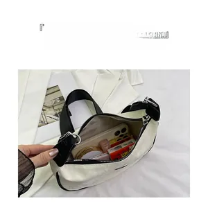 Detail showing high-capacity interior of creamy white hobo bag with daily essentials