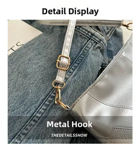 Macro detail of silver textured leather bag with premium gold metal hook and strap