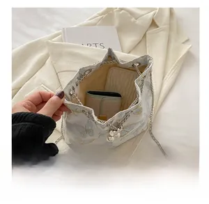 Internal capacity of the embroidered butterfly bucket bag showing space for a wallet and phone