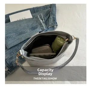 Silver tote bag interior showing capacity for umbrella, wallet and smartphone
