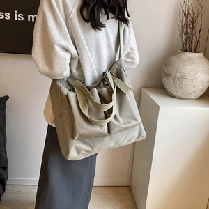 Large olive green nylon tote bag for women with multiple pockets and wide shoulder strap