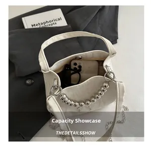 Interior view of white embossed bucket bag showing capacity for phone and glasses