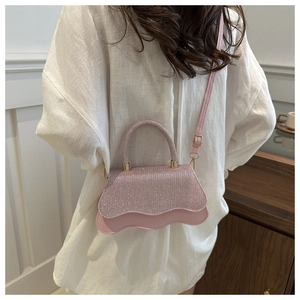 Detailed back view of pink sequined handbag with wavy edges and golden metal hardware