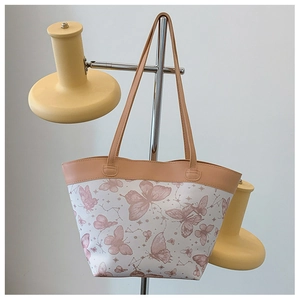 Detail of elegant butterfly print tote bag with contrast piping and twin shoulder straps