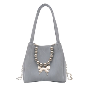 Elegant grey-blue bucket bag with metallic butterfly pendant and chain strap