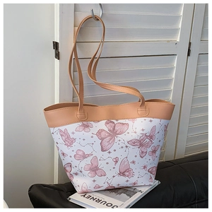 French style tote bag with butterfly print and khaki leather straps on white background