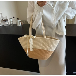 Detail of woven tote bag with white lace bow and contrasting beige cotton rope texture
