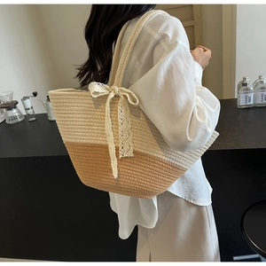 Detail of contrast woven straw bag with lace bow accessory in a cafe setting