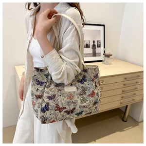 Detailed close-up of butterfly woven tote bag with premium leather handle and brand tag