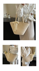 Macro detail of creamy white woven tote bag featuring delicate lace bow and textured fiber