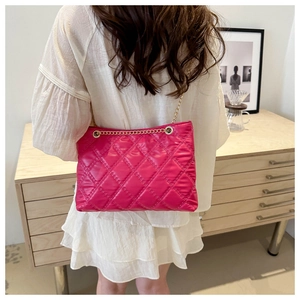 Detail of rose pink quilted diamond tote bag with elegant gold chain shoulder strap