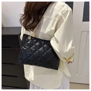 Quilted black shoulder bag with gold chain strap featuring a glossy diamond pattern