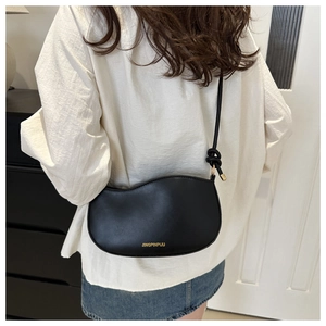 Elegant black half-moon crossbody bag for women with unique knotted shoulder strap