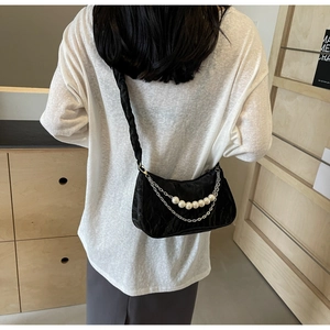 Pleated black half-moon shoulder bag with pearl chain and ruffled strap detail