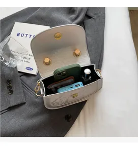 Internal view of the white saddle bag showing ample storage for phone and accessories