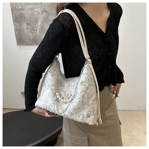 Chic cream crescent bag with butterfly prints, pearl beads, and tweed texture accents