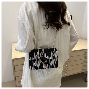 Minimalist black chain crossbody bag with colorful embroidery and gold square buckle