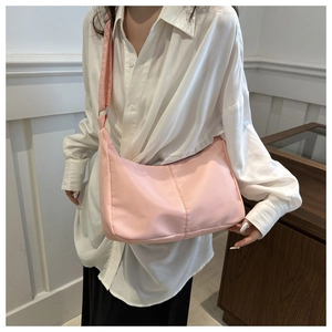 Detailed shot of pink Oxford cloth crescent crossbody bag with adjustable wide strap