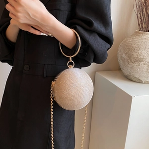 Champagne gold spherical evening bag with glitter texture and diamond-set handle
