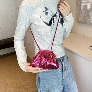 Metallic magenta drawstring crossbody cloud bag with pleated texture and thin strap