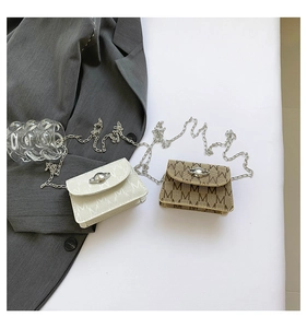 Detail of mini crossbody chain bags in white and brown with logo pattern and planet clasp