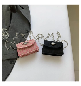 Detailed view of mini square chain bags in pink and black with iconic planet buckles