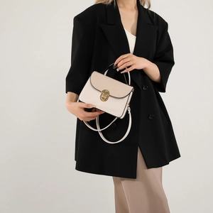 Elegant cream and beige contrast small square bag with gold twist lock and shoulder strap