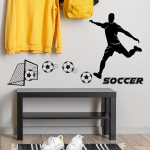 Détail de stickers muraux foot noir montrant une silhouette de joueur et texte sur le mur