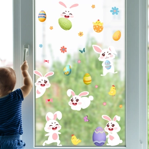 Close-up of Easter rabbit and colorful egg static window stickers on clear glass