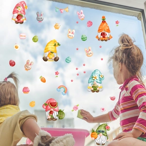 Detail of Easter bunny gnomes window stickers applied on glass with children playing