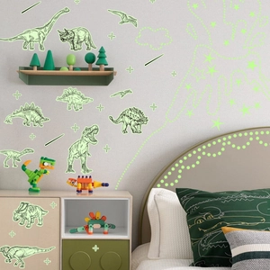 Detail of glow-in-the-dark dinosaur and star wall stickers set on a bedroom wall